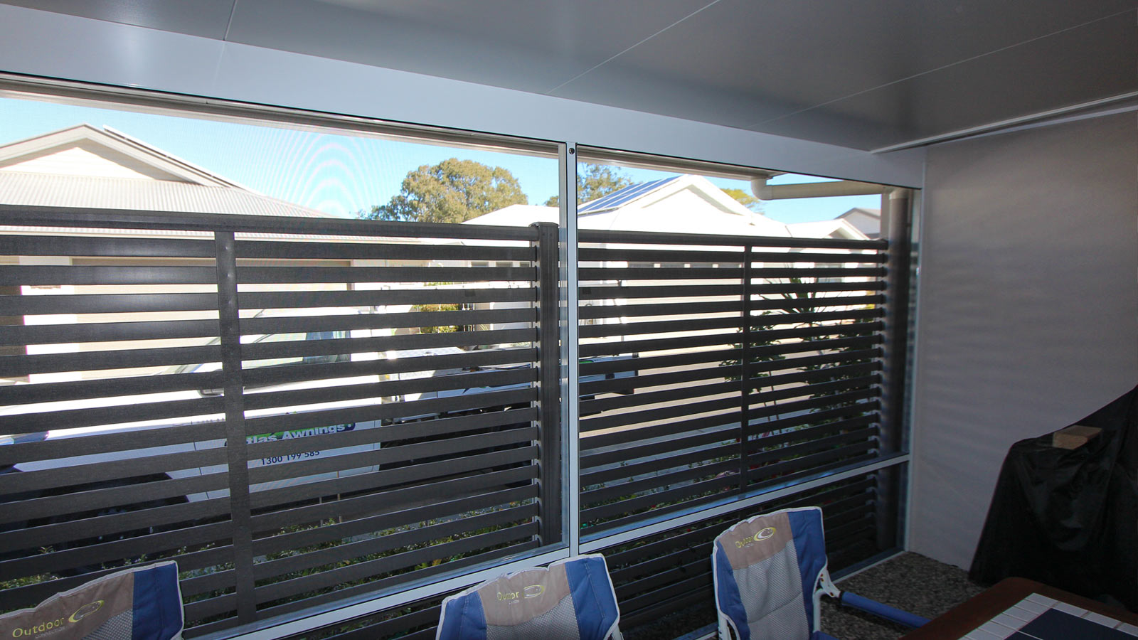The completed screen room for the patio, complete with permanent outdoor furniture